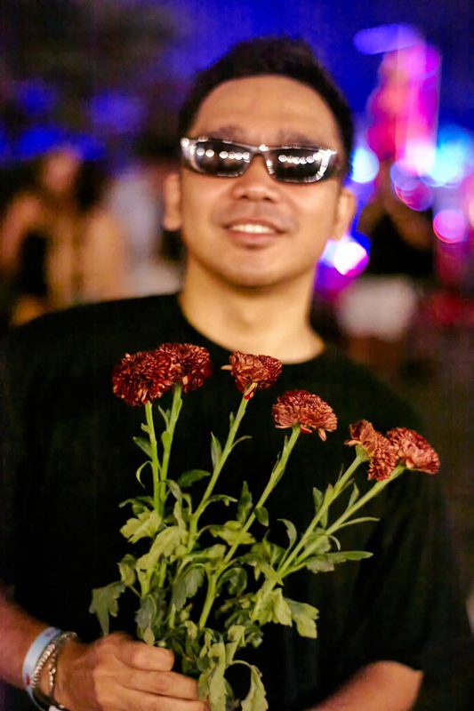 Festival guest holding compost-grown flowers