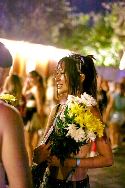 Festival guest with flowers at Day Zero Bali