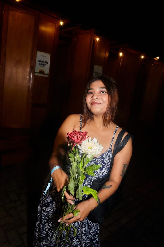 Festival guest with flowers at Day Zero Bali
