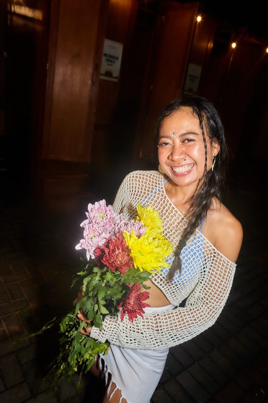 Festival guest with flowers at Day Zero Bali