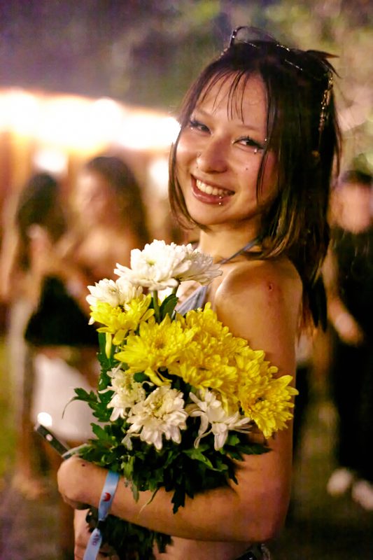 Festival guest with flowers at Day Zero Bali