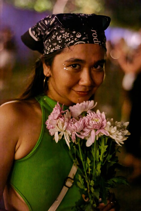 Festival guest with flowers at Day Zero Bali