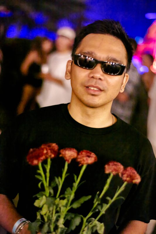 Festival guest with flowers at Day Zero Bali
