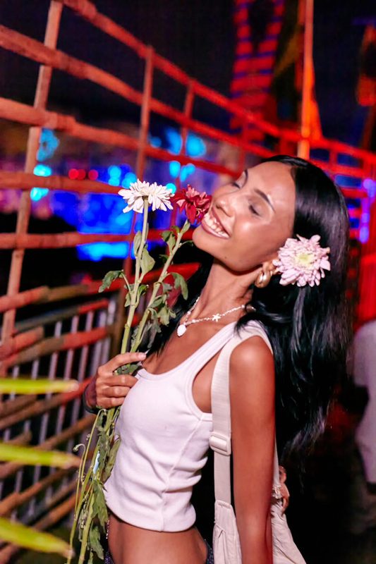 Festival guest with flowers at Day Zero Bali
