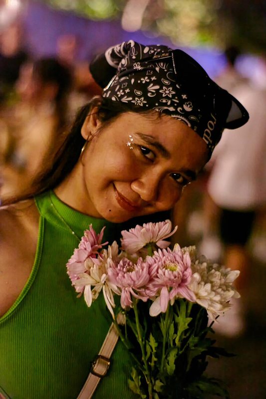 Festival guest with flowers at Day Zero Bali