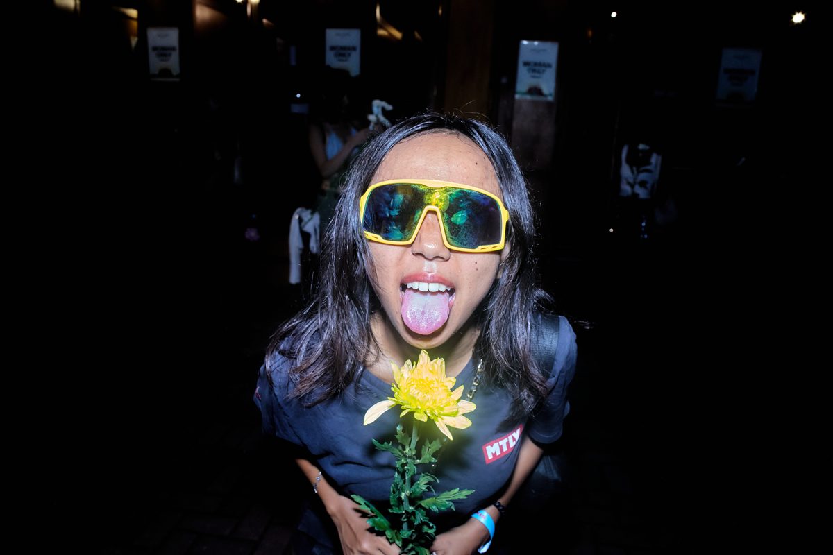 Festival guest with flowers at Day Zero Bali