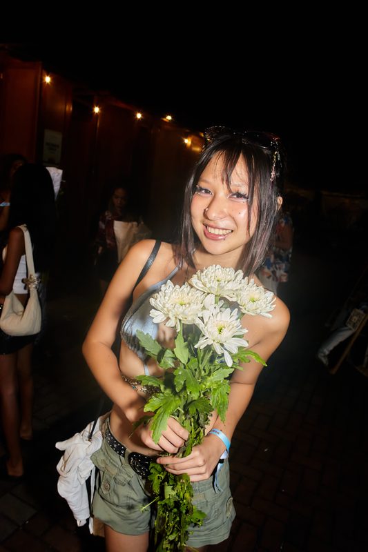 Festival guest with flowers at Day Zero Bali