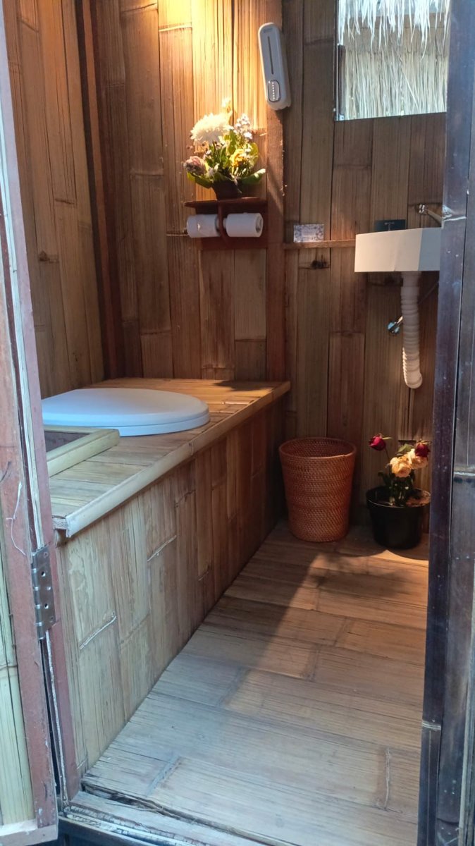 Inside the bamboo composting toilet — flowers, clean design