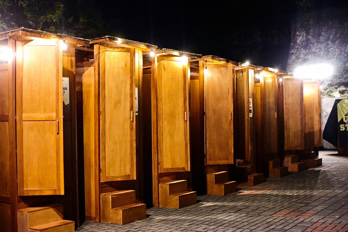 Ecoranah teak toilet units in daylight at festival